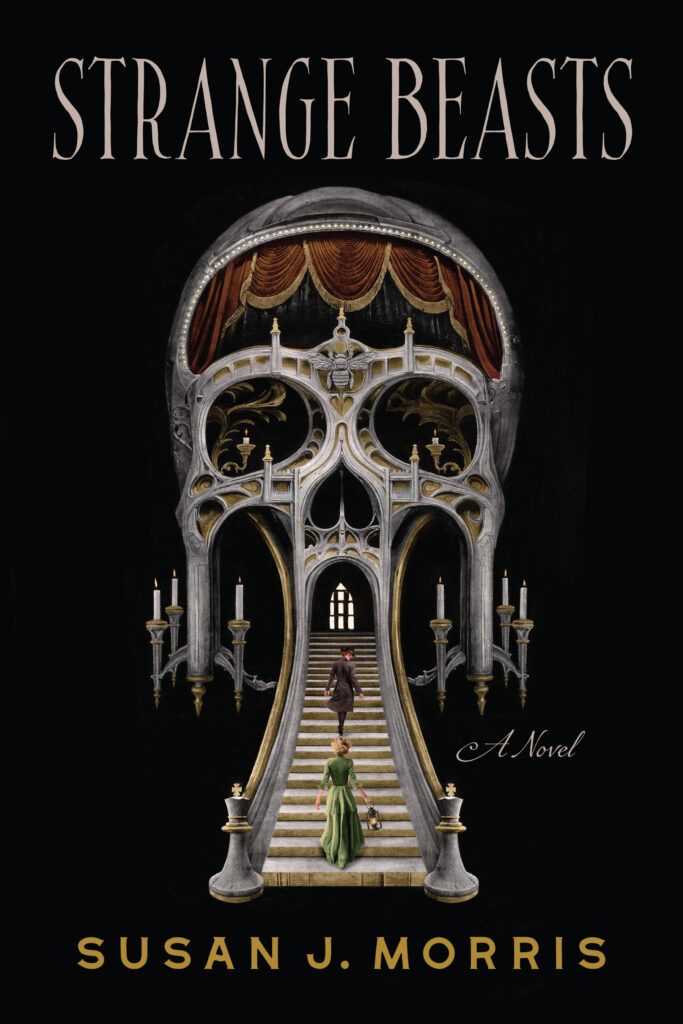 A surrealist picture of a skull combined with the Palais Garnier, with two women walking up the steps into it's mouth, one dressed in green holding a lantern, following another in a brown trenchcoat and hat. The title is STRANGE BEASTS and the author is SUSAN J. MORRIS